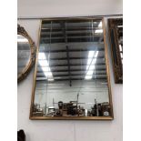 A LARGE GILT FRAMED MIRROR 95 x 64cm