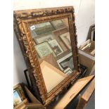 A GILT FRAMED MIRROR 84 x 63cm