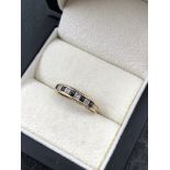 A 9ct HALLMARKED GOLD SAPPHIRE AND DIAMOND HALF ETERNITY RING. FINGER SIZE O. WEIGHT 1.40grms.