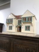 A TWIN GABLED DOLLS HOUSE