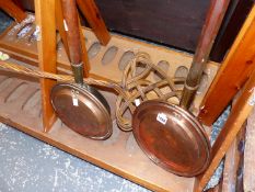 TWO WARMING PANS AND A CARPET BEATER.