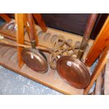 TWO WARMING PANS AND A CARPET BEATER.