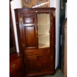 A GOOD GEORGE III OAK PANELLED FLOOR STANDING CORNER CABINET.