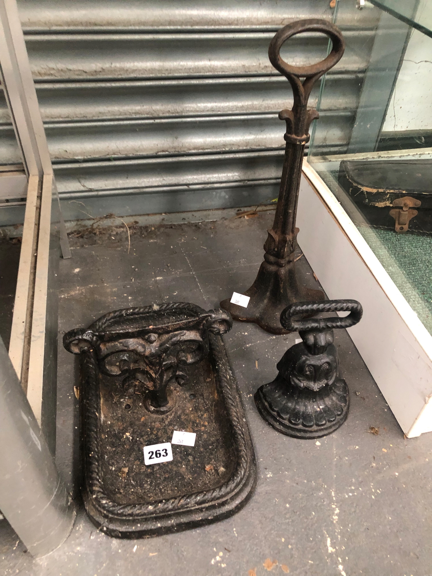 TWO IRON DOOR STOPS TOGETHER WITH AN IRON BOOT SCRAPER