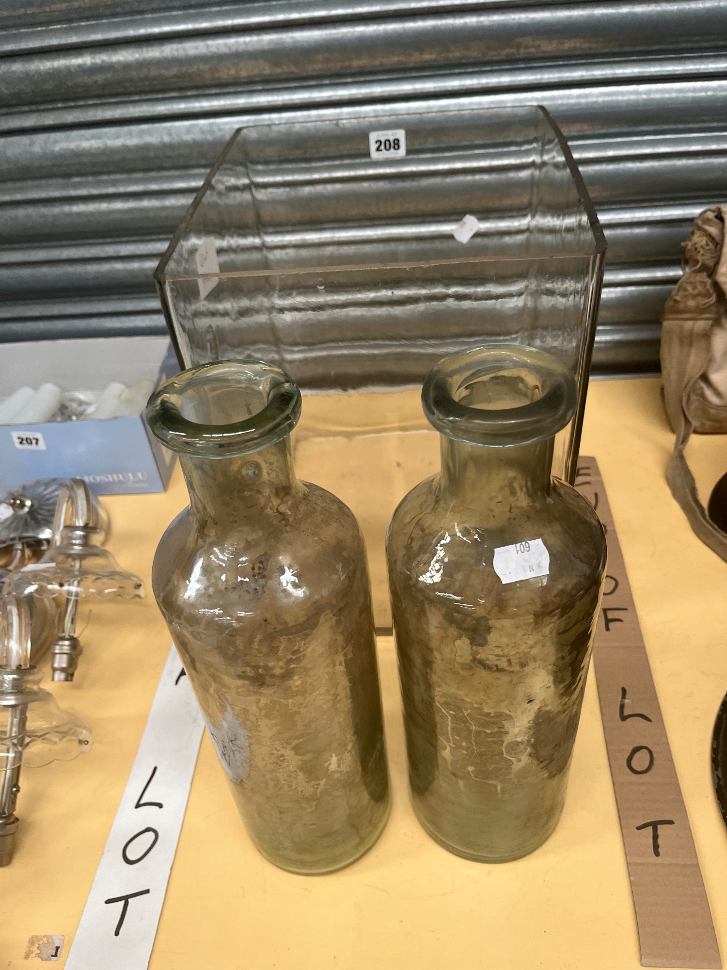 A CLEAR GLASS RECTANGULAR TANK TOGETHER WITH TWO LARGE BOTTLES