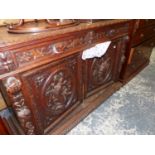 A FRENCH CARVED OAK SIDE CABINET.