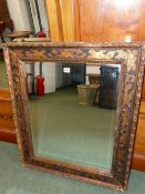 AN EARLY 20th CENTURY CARVED GILDED MIRROR FRAME.