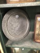AN ISLAMIC GREY METAL DISH WORKED WITH A HORSE BORNE ARCHER