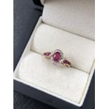 A RUBY AND DIAMOND CLUSTER TYPE RING. NO ASSAY MARKS, STAMPED 10K, ASSESSED AS 10ct GOLD. FINGER