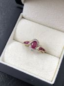A RUBY AND DIAMOND CLUSTER TYPE RING. NO ASSAY MARKS, STAMPED 10K, ASSESSED AS 10ct GOLD. FINGER