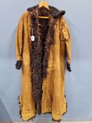 AN EARLY 20TH CENTURY INDIAN FUR LINED LEATHER COAT EMBROIDERED IN YELLOW THREAD WITH STYLISED BUD