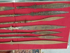 SIX AFRICAN SPEAR SHAFTS, ELEVEN VARIOUS BLADES AND POINTS TOGETHER WITH A KHRIS IN A WOODEN