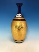 A JAPANESE PORCELAIN VASE, THE BLUE GLAZED WAISTED NECK ABOVE AN OVOID BODY GILT IN RELIEF WITH