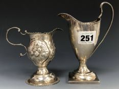 A GEORGE III REPOUSSE SILVER CREAM JUG BY CHARLES HOUGHAM, LONDON 1773, A GEORGE III SILVER HELMET