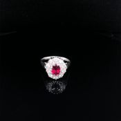 AN 18ct WHITE GOLD HALLMARKED AND HIGH QUALITY RUBY AND DIAMOND CLUSTER RING. THE OVAL CLAW SET RUBY