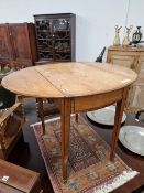 A GEORGE III CROSS BANDED SATIN WOOD OVAL DROP FLAP TABLE, THE SQUARE SECTIONED LEGS TAPERING TO