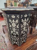 AN ISLAMIC HARDWOOD OCTAGONAL TABLE INLAID WITH BONE AND MOTHER OF PEARL FLOWERS AND THEIR