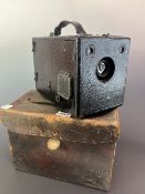 A BLACK LEATHERETTE BOX CAMERA WITH A LEATHER CARRYING CASE LABELLED FOR THE LONDON STEREOSCOPIC &