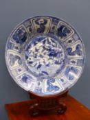 A CHINESE BLUE AND WHITE KRAAK DISH, THE CENTRE PAINTED WITH WATER FOWL BY A WATER BANK AND WITHIN
