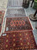 FOUR SMALL ORIENTAL RUGS OF BOKHARA DESIGN. LARGEST 155 x 93cms (4)
