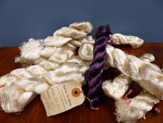 A COLLECTION OF ANTIQUE MAINLY CREAM SEWING SILKS TIED INTO SPIRAL BUNDLES