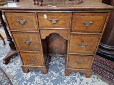A 19th C. MAHOGANY KNEEHOLE DESK, THE CROSS BANDED TOP OVER A KNEEHOLE CUPBOARD RECESSED AND FLANKED