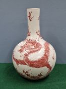 A CHINESE UNDERGLAZE RED BOTTLE VASE DECORATED WITH A DRAGON CHASING A FLAMING PEARL, SEAL MARK IN