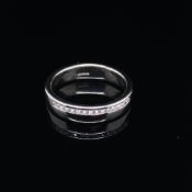 A PLATINUM AND DIAMOND SET WEDDING BAND RING. FINGER SIZE J. WEIGHT 6.72grms.
