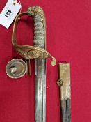 A 19t C. NAVAL SWORD IN A BRASS MOUNTED LEATHER SCABBARD, THE WIRE BOUND SHAGREEN HANDLE ABOVE