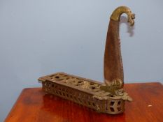 AN INDIAN WROUGHT IRON BOTI OR VEGETABLE CUTTER. THE BLADE HEADED BY A BRASS BIRDS HEAD AND