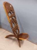 AN AFRICAN CARVED HARDWOOD "BIRTHING" CHAIR.