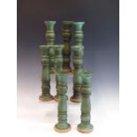 A SET OF EIGHT TURNED WOOD CANDLESTICKS WITH BIRDS EGG BLUE PAINTED DECORATION.