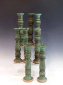 A SET OF EIGHT TURNED WOOD CANDLESTICKS WITH BIRDS EGG BLUE PAINTED DECORATION.