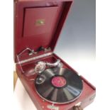 A VINTAGE HMV (HIS MASTERS VOICE) PORTABLE GRAMOPHONE IN RARE RED LETHERETTE COVERED OUTER.