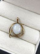 A VINTAGE OVAL OPAL PENDANT IN AN RUB OVER AND STYLISED SETTING. THE BAIL STAMPED 9ct EH. ASSESSED