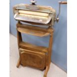 A VINTAGE ACME no55 HOUSEHOLD MANGLE ON ORIGINAL STAND.