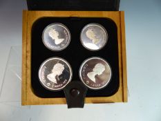 A 1976 MONTREAL OLYMPICS SILVER COMMEMORATIVE CANADIAN COIN SET BY COJO TO INCLUDE 2 X $10 & 2 X $