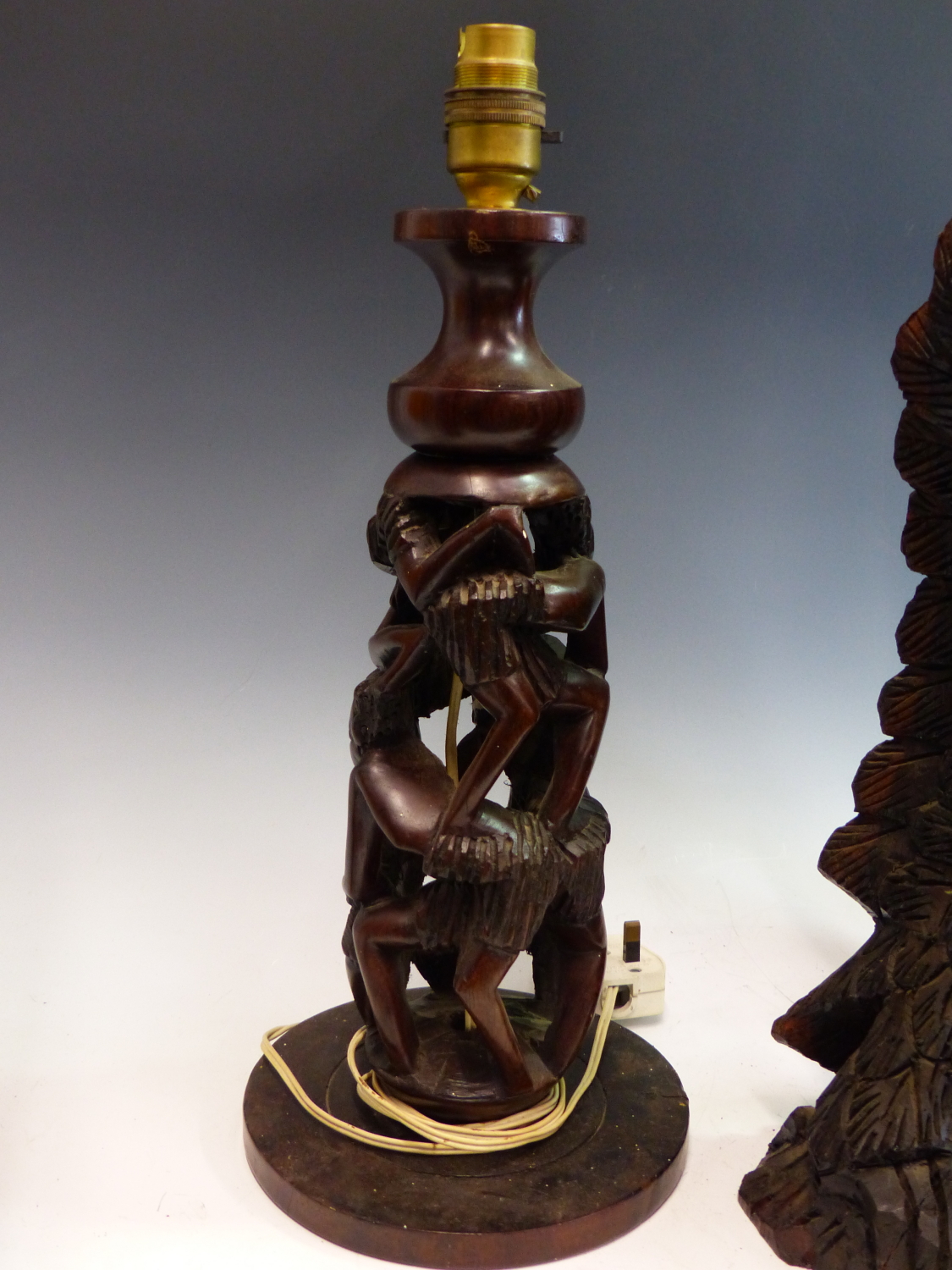 TWO AFRICAN HARDWOOD STANDING FIGURES, A PAIR OF HEADS, A RELIEF CARVED PLAQUE, A TABLE LAMP PIERCED - Image 2 of 3