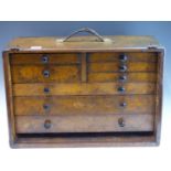A VINTAGE WOODEN TOOL CHEST OF MULTIPLE DRAWERS, SOME CONTAINING MILLING AND OTHER TOOLS.