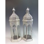 A PAIR OF PAINTED GLAZED HANGING CANDLE LANTERNS.