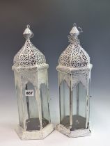A PAIR OF PAINTED GLAZED HANGING CANDLE LANTERNS.