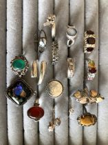 A COLLECTION OF 15 SILVER RINGS AND A SILVER MOUNTED BUTTERFLY WING PENDANT. GROSS WEIGHT 67.03grms.