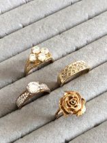 FOUR 9ct HALLMARKED RINGS TO INCLUDE A DIAMOND SET BAND, A ROSE STYLISED RING, A CZ SOLITAIRE, AND A