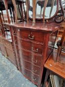 A SERPENTINE FRONT TALL DRESSING CHEST WITH MIRROR BACK