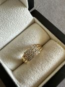 A TWELVE STONE DIAMOND SET RING, THE RING WITH POSSIBLE FRENCH HALLMARKS, ASSESSED AS 18ct GOLD.