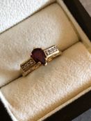 A 9ct GOLD HALLMARKED PEAR CUT GARNET RING. FINGER SIZE N. WEIGHT 3.93grms