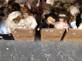 A LARGE COLLECTION OF DECORATIVE MODERN BISQUE HEAD DOLLS - UNBOXED IN VERY GOOD CONDITION.
