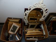 A PAINTED ORNATE OVAL MIRROR AND A QUANTITY OF PICTURE FRAMES