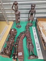 FOUR AFRICAN CARVED WOOD FIGURE, A BEAN RATTLE AND A NECKLACE.