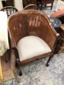 A CANED TUB ARM CHAIR